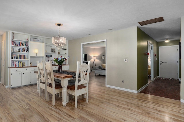 1511 E University St, Springfield, MO 65804 - dining space with light wood-style floors, baseboards, and a chandelier