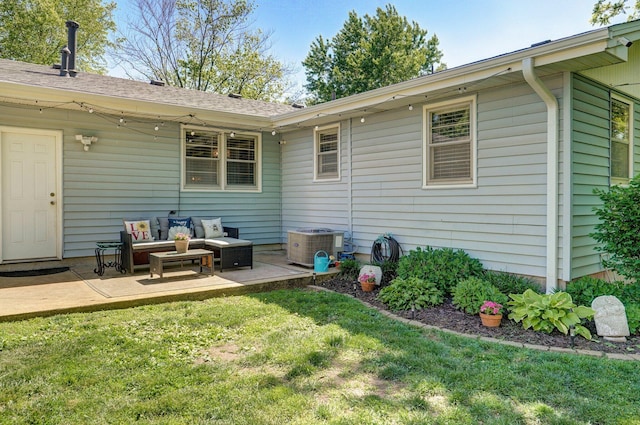 1511 E University St, Springfield, MO 65804 - rear view of property with an outdoor living space, a patio area, a yard, and central AC unit