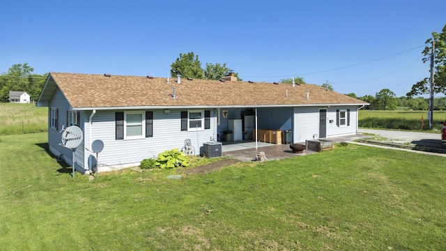5680 N Farm Rd Unit 215, Strafford, MO 65757 - back of house featuring a lawn, a patio, a shingled roof, and a chimney