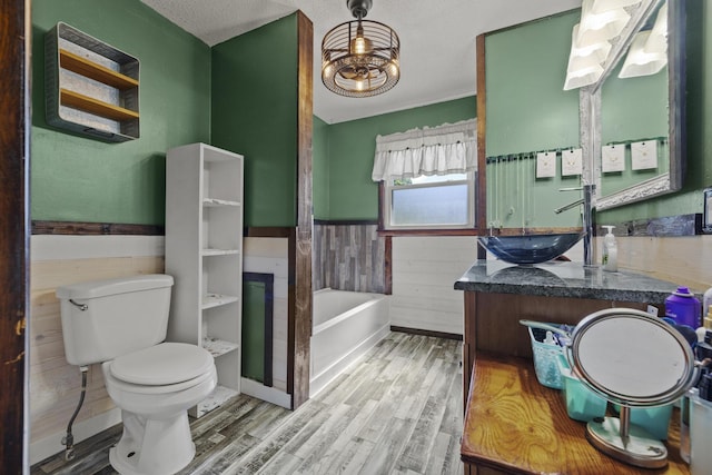5680 N Farm Rd Unit 215, Strafford, MO 65757 - bathroom with toilet, wainscoting, wood finished floors, a bath, and vanity