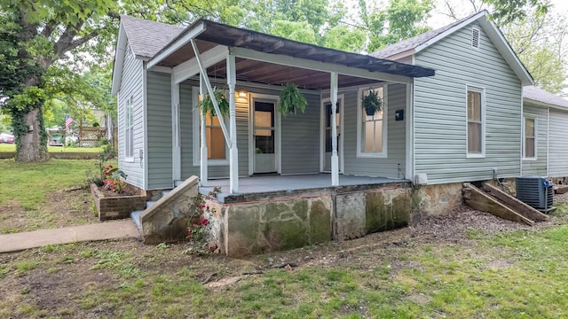 222 Poplar St, Thayer, MO 65791 - view of front facade featuring covered porch, roof with shingles, and central air condition unit