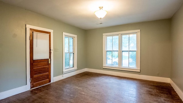 222 Poplar St, Thayer, MO 65791 - spare room featuring healthy amount of natural light, dark wood-type flooring, and baseboards
