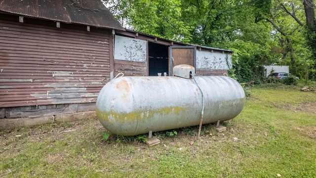 222 Poplar St, Thayer, MO 65791 - exterior view of propane tank and metal roof