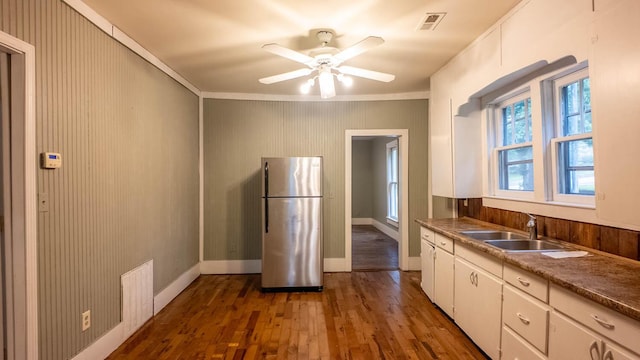 222 Poplar St, Thayer, MO 65791 - kitchen with freestanding refrigerator, a sink, dark wood finished floors, crown molding, and white cabinetry