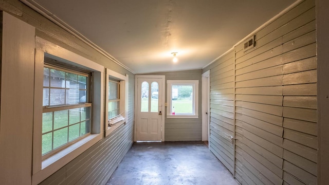 222 Poplar St, Thayer, MO 65791 - doorway featuring concrete floors, wooden walls, and crown molding