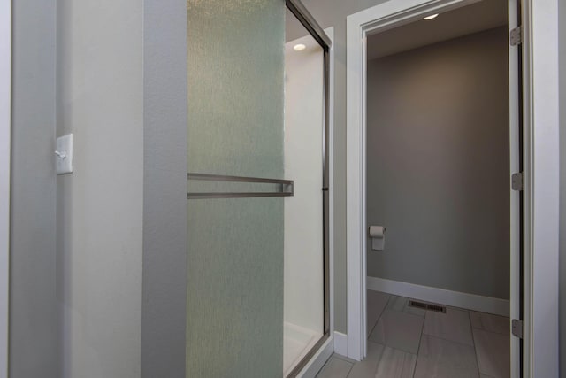 622 N Rockingham Ave, Nixa, MO 65714 - bathroom featuring a shower stall, baseboards, and tile patterned floors