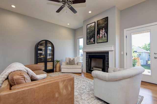 622 N Rockingham Ave, Nixa, MO 65714 - living area featuring a tile fireplace, light wood-style floors, ceiling fan, recessed lighting, and vaulted ceiling
