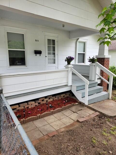 521 W Hunter St, Nevada, MO 64772 - doorway to property featuring covered porch