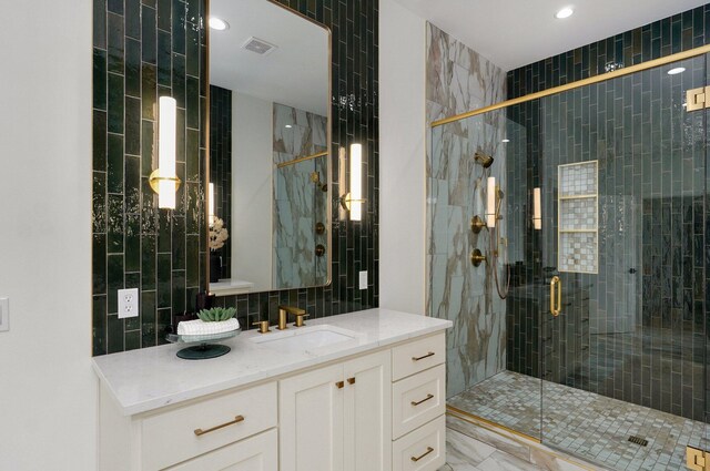 1744 E Cobblestone Dr, Ozark, MO 65721 - bathroom featuring vanity, a stall shower, tile walls, tasteful backsplash, and marble finish floors