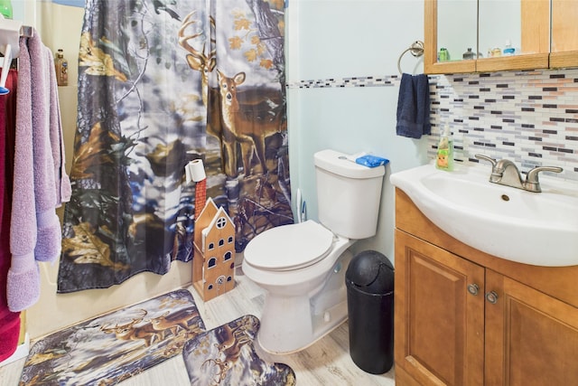 8385 Sate Highway 5, Gainesville, MO 65655 - bathroom with vanity, backsplash, toilet, and wood finished floors