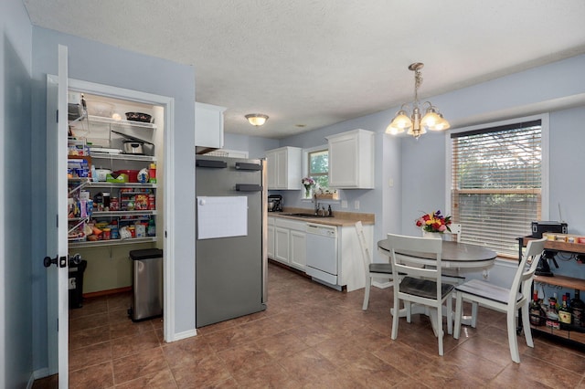 1141 N Hilton Ave, Springfield, MO 65803 - kitchen featuring white dishwasher, refrigerator, a chandelier, white cabinetry, and light countertops