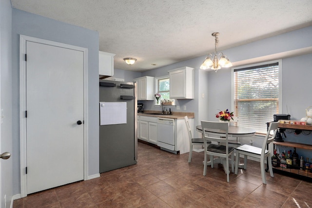 1141 N Hilton Ave, Springfield, MO 65803 - kitchen with dishwasher, freestanding refrigerator, a chandelier, white cabinets, and a sink