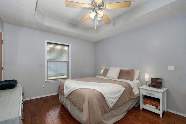 1141 N Hilton Ave, Springfield, MO 65803 - bedroom with baseboards, hardwood / wood-style floors, a tray ceiling, and a ceiling fan