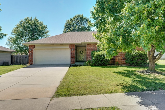 1141 N Hilton Ave, Springfield, MO 65803 - view of front of house featuring an attached garage, cooling unit, driveway, and brick siding