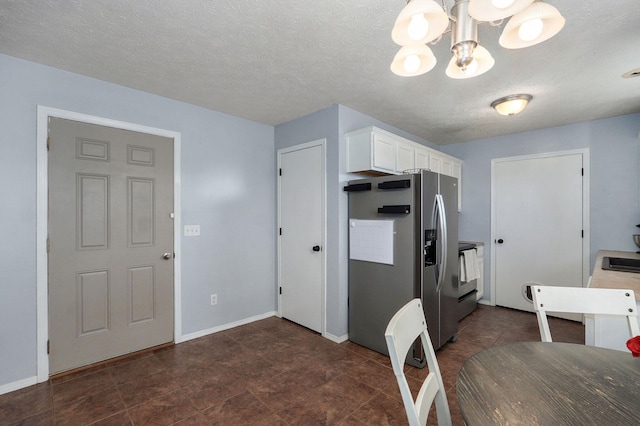 1141 N Hilton Ave, Springfield, MO 65803 - kitchen with stainless steel fridge with ice dispenser, a chandelier, white cabinets, baseboards, and a textured ceiling