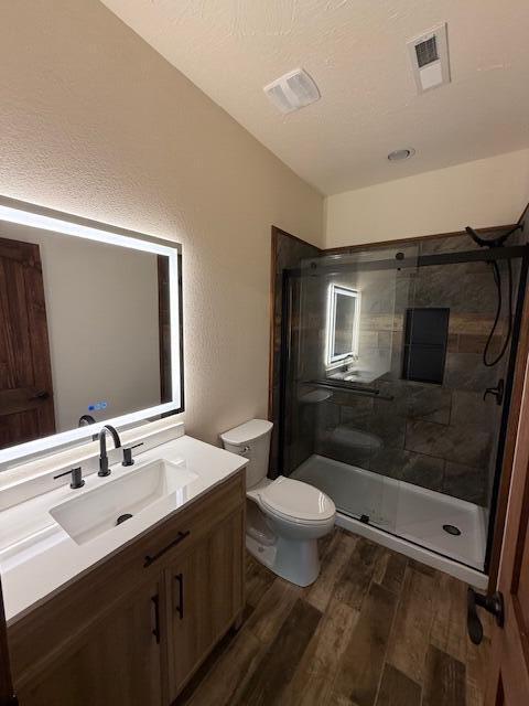 429 E S St, Mountain Grove, MO 65711 - full bathroom with wood finished floors, vanity, toilet, and a shower stall