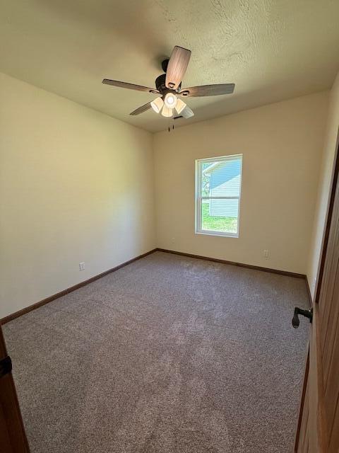 429 E S St, Mountain Grove, MO 65711 - spare room with ceiling fan, carpet floors, and baseboards