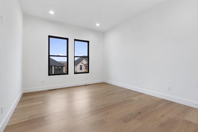 1702 E Cobblestone Dr, Ozark, MO 65721 - empty room with light wood finished floors, recessed lighting, and baseboards