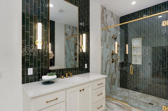 1702 E Cobblestone Dr, Ozark, MO 65721 - full bath with vanity, a stall shower, tile walls, tasteful backsplash, and marble finish floors