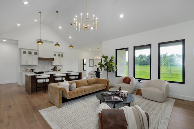 1702 E Cobblestone Dr, Ozark, MO 65721 - living area featuring a chandelier, high vaulted ceiling, light wood-style flooring, recessed lighting, and baseboards