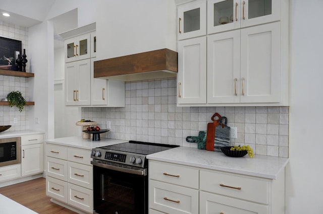 1702 E Cobblestone Dr, Ozark, MO 65721 - kitchen featuring stainless steel range with electric stovetop, open shelves, built in microwave, tasteful backsplash, and white cabinetry