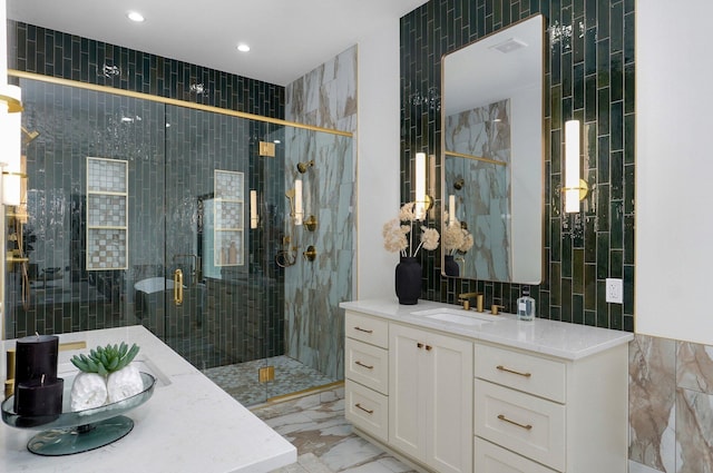 1702 E Cobblestone Dr, Ozark, MO 65721 - bathroom featuring tile walls, vanity, marble finish floors, a shower stall, and recessed lighting