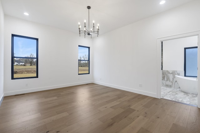1702 E Cobblestone Dr, Ozark, MO 65721 - spare room featuring wood finished floors, a chandelier, recessed lighting, and baseboards