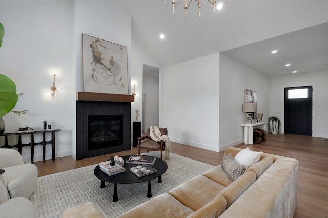 1702 E Cobblestone Dr, Ozark, MO 65721 - living area with a tile fireplace, wood finished floors, baseboards, recessed lighting, and a chandelier