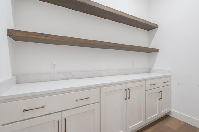 1702 E Cobblestone Dr, Ozark, MO 65721 - detailed view of wood finished floors and baseboards