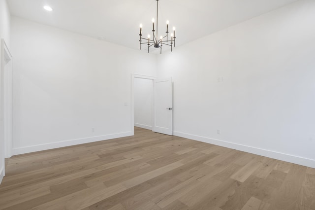 1702 E Cobblestone Dr, Ozark, MO 65721 - empty room with a chandelier, light wood-type flooring, and baseboards