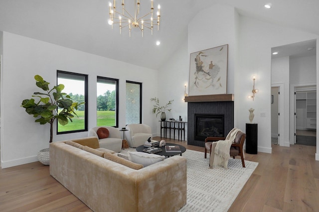 1702 E Cobblestone Dr, Ozark, MO 65721 - living room featuring high vaulted ceiling, light wood-style floors, a glass covered fireplace, baseboards, and recessed lighting