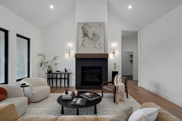 1702 E Cobblestone Dr, Ozark, MO 65721 - living area with high vaulted ceiling, a fireplace, wood finished floors, baseboards, and recessed lighting