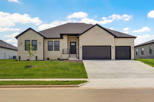 1702 E Cobblestone Dr, Ozark, MO 65721 - french country inspired facade featuring a garage, brick siding, a front yard, and concrete driveway
