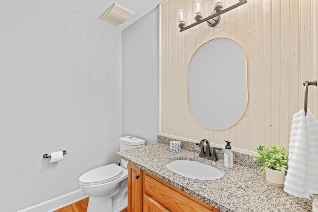 8205 Quail Ridge Ct, Nixa, MO 65714 - bathroom with vanity, toilet, wood finished floors, and baseboards