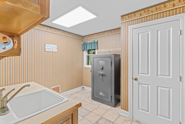 8205 Quail Ridge Ct, Nixa, MO 65714 - laundry area with light tile patterned floors, wallpapered walls, and baseboards