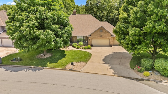8205 Quail Ridge Ct, Nixa, MO 65714 - view of front of house featuring driveway, a garage, brick siding, a front lawn, and roof with shingles