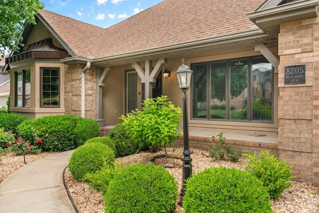 8205 Quail Ridge Ct, Nixa, MO 65714 - property entrance with roof with shingles and brick siding