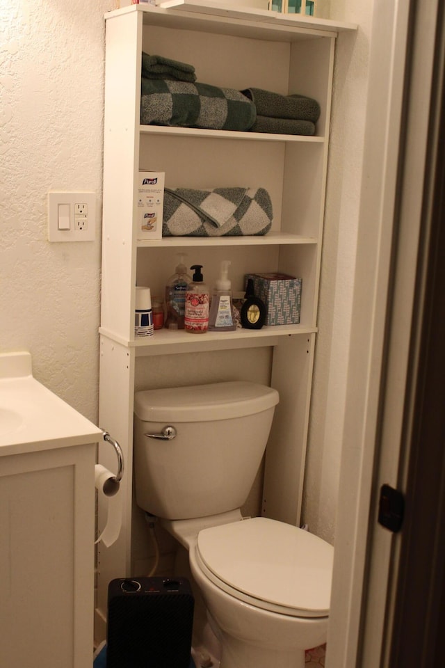 1012 E 3rd St, Monett, MO 65708 - bathroom featuring toilet, a textured wall, and vanity