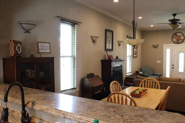 1012 E 3rd St, Monett, MO 65708 - dining area with healthy amount of natural light, ceiling fan, crown molding, and recessed lighting