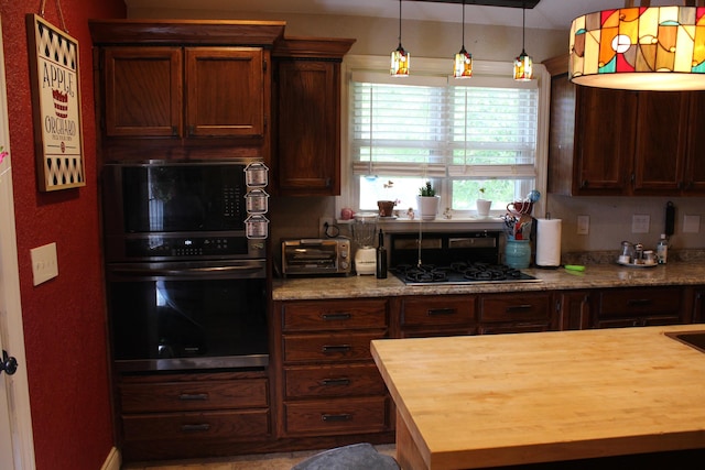 1012 E 3rd St, Monett, MO 65708 - kitchen with butcher block counters, stainless steel gas stovetop, and decorative light fixtures