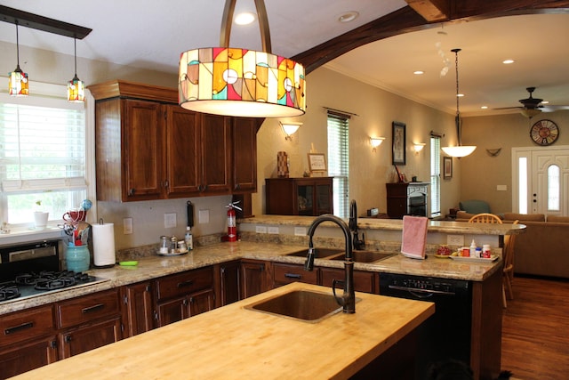 1012 E 3rd St, Monett, MO 65708 - kitchen featuring butcher block counters, dishwasher, gas stovetop, a sink, and healthy amount of natural light