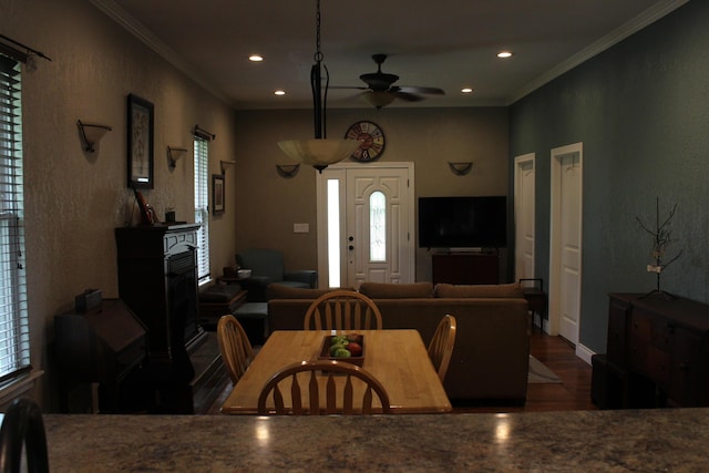 1012 E 3rd St, Monett, MO 65708 - dining area featuring wood finished floors, crown molding, ceiling fan, a fireplace, and recessed lighting