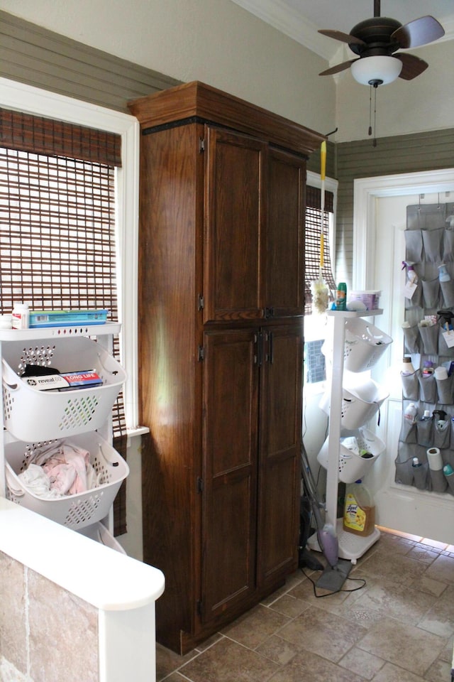 1012 E 3rd St, Monett, MO 65708 - kitchen featuring light stone finish flooring, ceiling fan, crown molding, and healthy amount of natural light