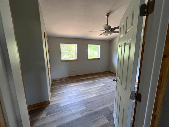 000 Reid Dr, Theodosia, MO 65761 - unfurnished bedroom with baseboards, wood finished floors, and a ceiling fan