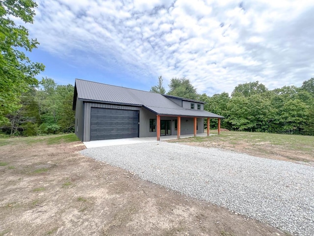 000 Reid Dr, Theodosia, MO 65761 - view of front of house featuring driveway, metal roof, an attached garage, and covered porch
