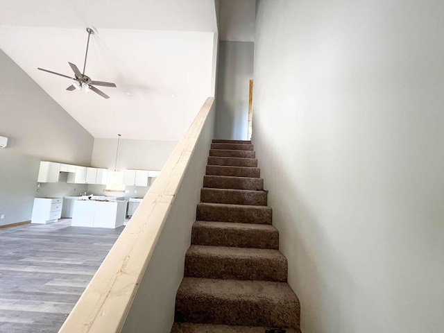 000 Reid Dr, Theodosia, MO 65761 - stairs with a ceiling fan, high vaulted ceiling, wood finished floors, and baseboards