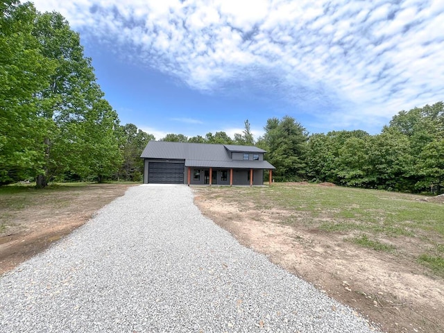 000 Reid Dr, Theodosia, MO 65761 - view of front of house with a garage, driveway, covered porch, and metal roof