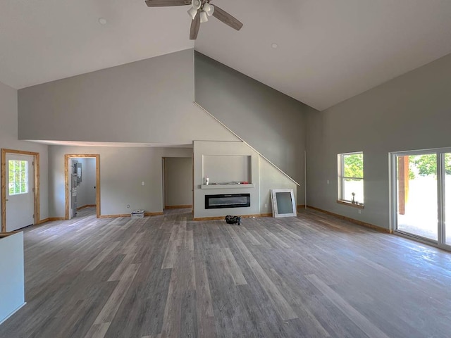 000 Reid Dr, Theodosia, MO 65761 - unfurnished living room with high vaulted ceiling, a ceiling fan, baseboards, and healthy amount of natural light