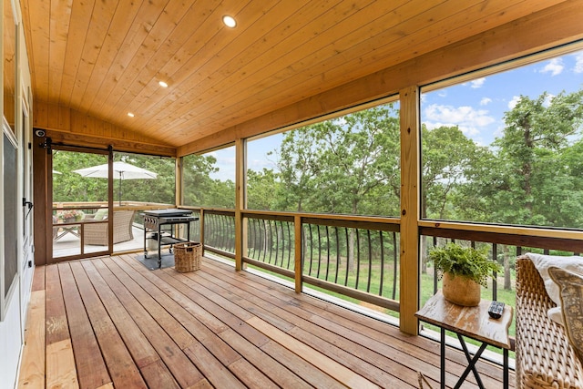 245 William Pl, Branson, MO 65616 - unfurnished sunroom featuring vaulted ceiling and view of wooded area