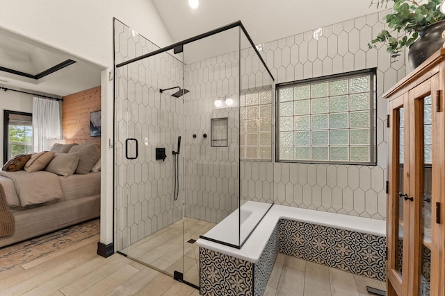 245 William Pl, Branson, MO 65616 - ensuite bathroom with a shower stall, a relaxing tiled tub, and wood finished floors